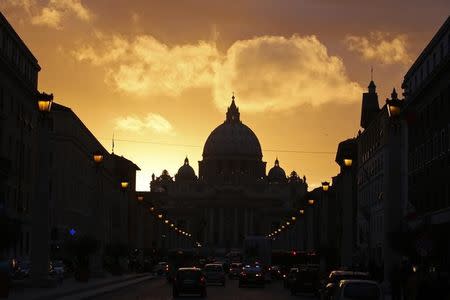 Saint Peter's Basilica at the Vatican is silhouetted during sunset in Rome, March 11, 2013. REUTERS/Paul Hanna/File Photo