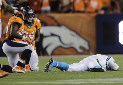 Carolina Panthers quarterback Cam Newton, right, took some vicious hits against the Denver Broncos (AP).