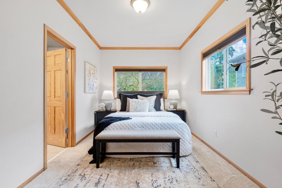 a white bedroom with multiple windows in the home where Jeff Bezos founded Amazon