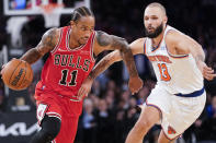 Chicago Bulls forward DeMar DeRozan (11) drives against New York Knicks guard Evan Fournier (13) in the second half of an NBA basketball game, Thursday, Dec. 2, 2021, at Madison Square Garden in New York. (AP Photo/Mary Altaffer)
