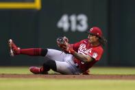 Cincinnati Reds second baseman Jonathan India makes a diving grab on a grounder hit by Arizona Diamondbacks' Nick Ahmed, before throwing to first base for the out during the fourth inning of a baseball game Saturday, April 10, 2021, in Phoenix. (AP Photo/Ross D. Franklin)