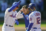 New York Mets' Michael Conforto, center, celebrates after being hit by a pitch and scoring the winning run on loaded bases during the ninth inning of a baseball game against the Miami Marlins, Thursday, April 8, 2021, in New York. (AP Photo/John Minchillo)