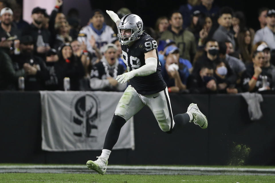 Las Vegas Raiders defensive end Maxx Crosby (98) celebrates after sacking Los Angeles Chargers quarterback Justin Herbert (10) during the second half of an NFL football game, Sunday, Jan. 9, 2022, in Las Vegas. (AP Photo/Ellen Schmidt)