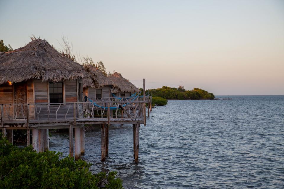 A view of the overwater bungalows at Thatch Caye resort in Belize.