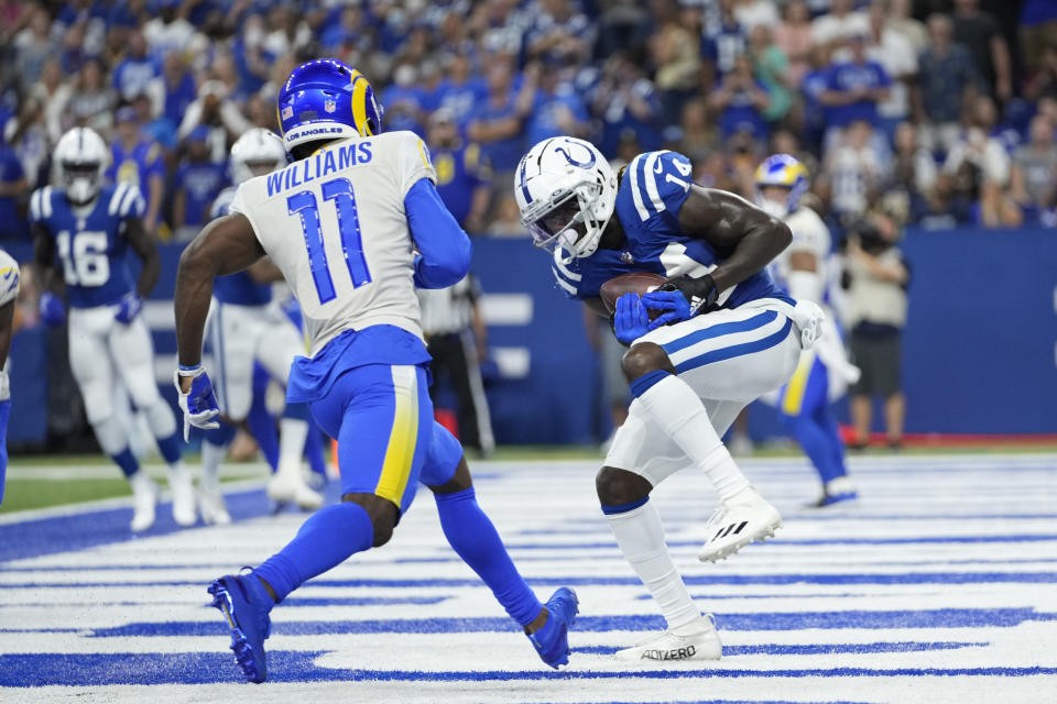 Indianapolis Colts' Zach Pascal (14) makes a touchdown reception against Los Angeles Rams' Darious Williams (11) during the second half of an NFL football game, Sunday, Sept. 19, 2021, in Indianapolis. (AP Photo/AJ Mast)