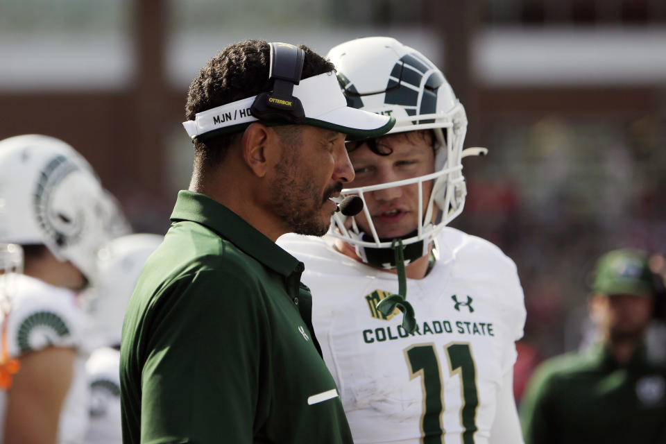 Colorado State head coach Jay Norvell, left, speaks with quarterback Clay Millen during the first half of an NCAA college football game against Washington State, Saturday, Sept. 17, 2022, in Pullman, Wash. (AP Photo/Young Kwak)