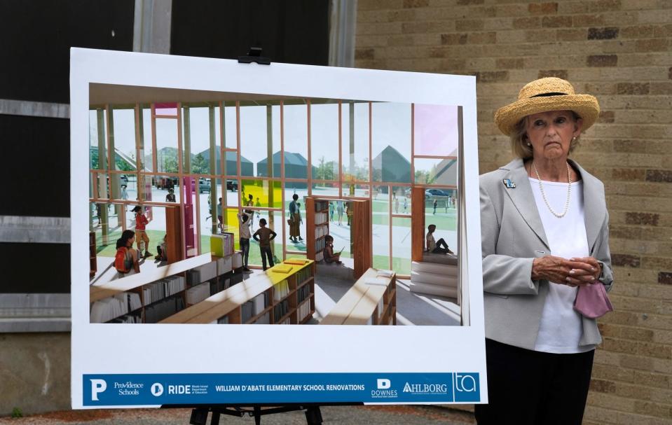 Denise D’Abate Orton, daughter of the late Providence City Councilman William D’Abate, stands next to a rendering of some of the renovation planned at the Olneyville elementary school that bears her father's name.