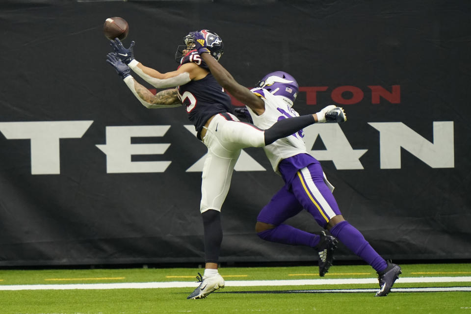 Houston Texans wide receiver Will Fuller (15) bobbles a catch in the end zone as Minnesota Vikings defensive back Holton Hill (24) defends the play during the second half of an NFL football game Sunday, Oct. 4, 2020, in Houston. (AP Photo/David J. Phillip)