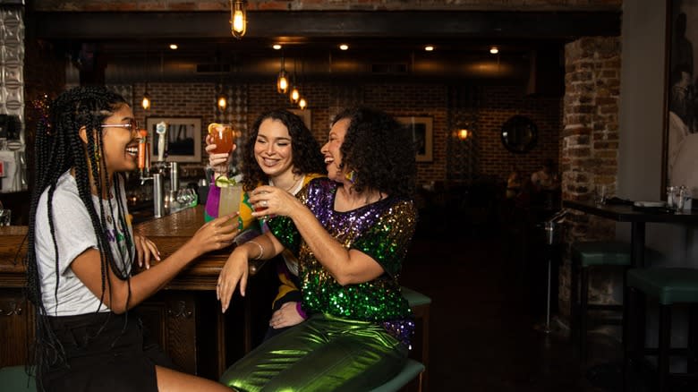 three women cheers at bar