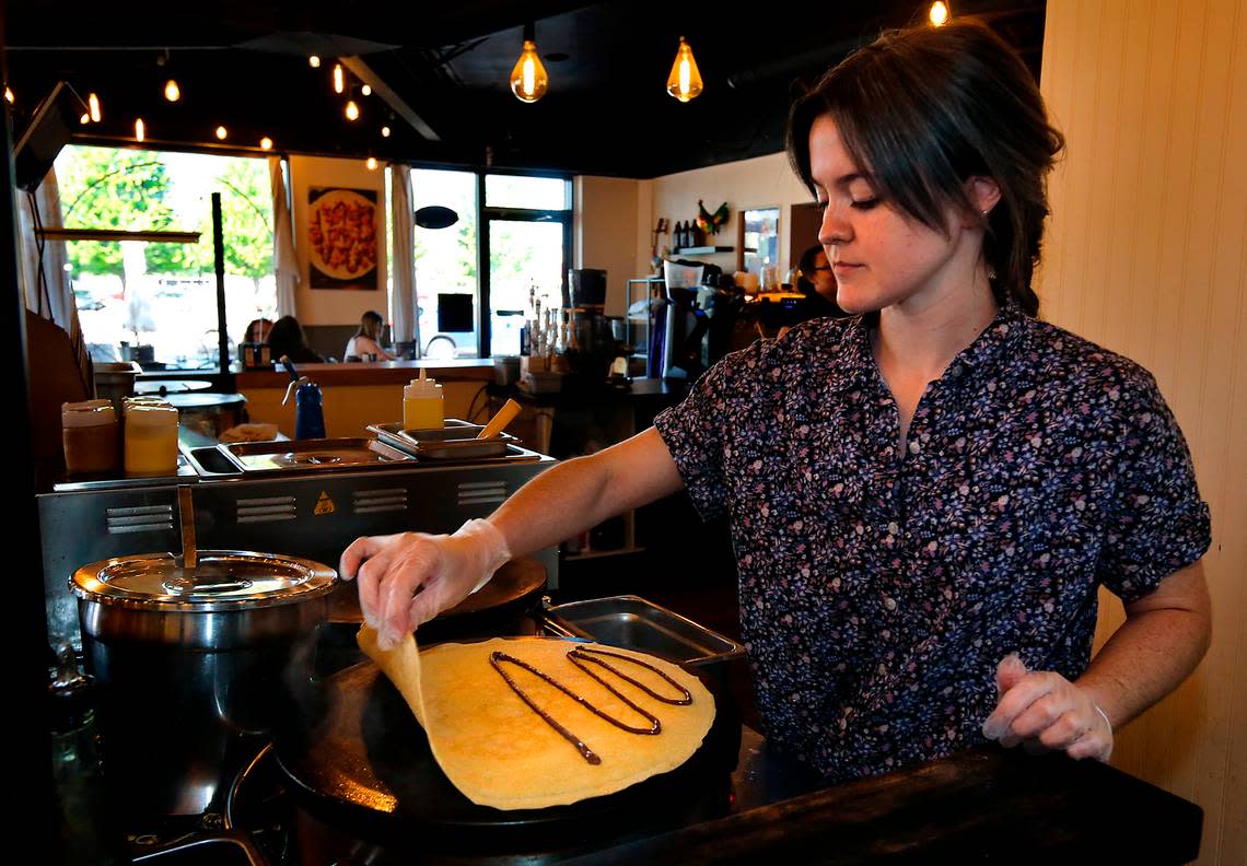 Emily Colby, store manager at Kagen Coffee & Crepes, cooks a Nutella strawberry banana crepe recently in the Uptown Shopping Center location in Richland.