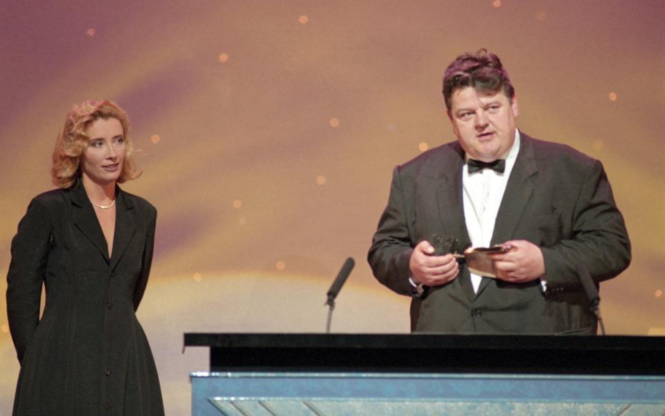 Robbie Coltrane receiving a Bafta award from Emma Thompson in 1996 - ITV/Shutterstock