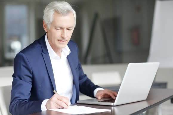 Older man working at a laptop