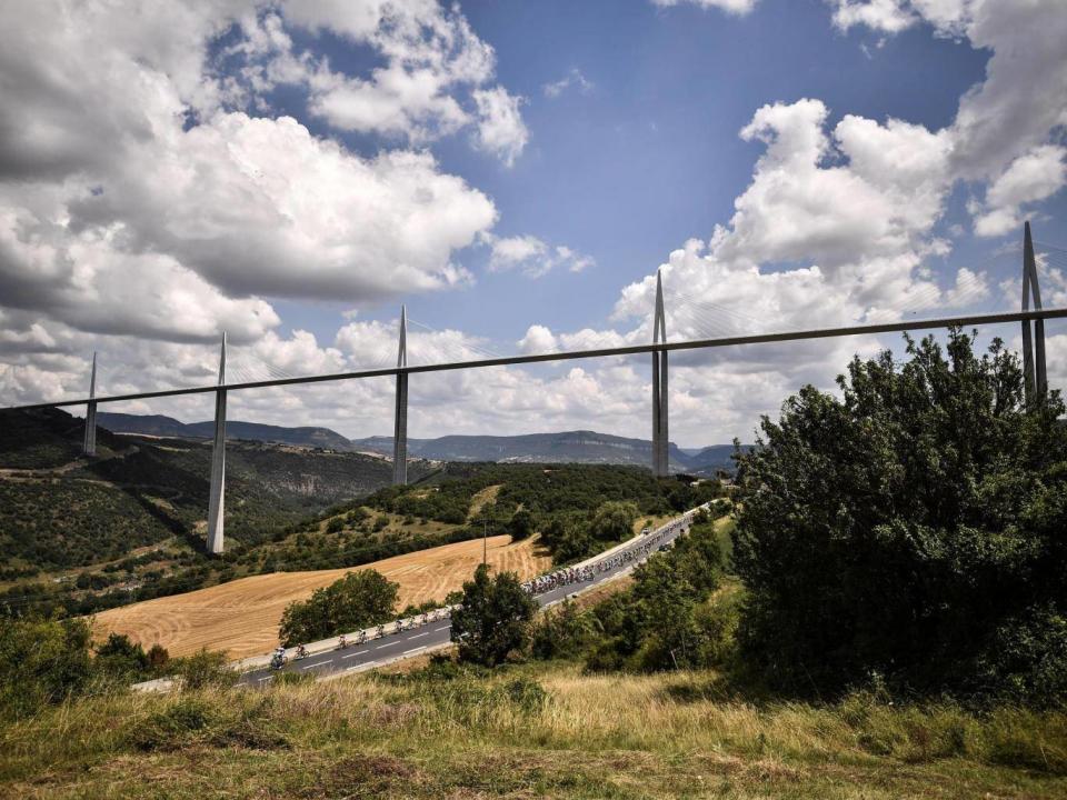 The peloton rides under the Millau Viaduct (AFP/Getty Images)