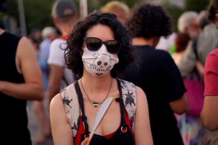 A woman takes part in a protest against Madrid's new conservative People's Party (PP) municipal government plans to suspend some anti-car emissions policies in the city center