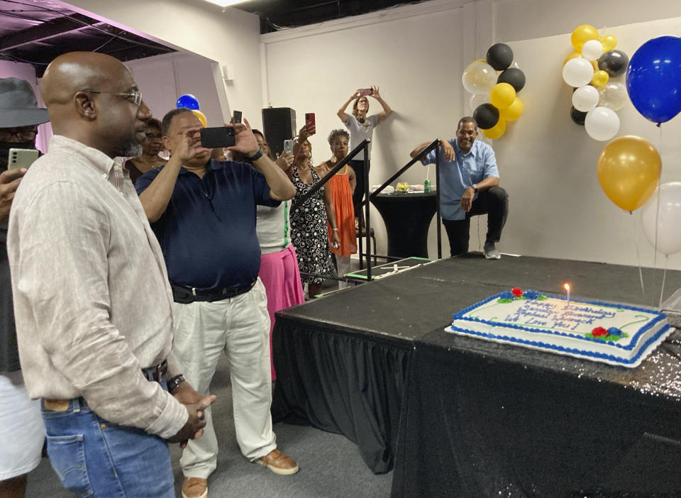 Georgia Sen. Raphael Warnock celebrates his 53rd birthday with supporters in southwest Atlanta as he seeks his first full term in the Senate, July 23, 2022. Warnock won a special election runoff in January 2021 in a completely nationalized campaign with Senate control coming down to two Georgia seats two months after President Joe Biden’s elections. Now, Biden’s political fortunes are down and inflation is up—and Warnock is running a deal-making, bipartisan senator who will “work with anybody” to help his state. He faces Republican challenger Herschel Walker. Warnock is running for his first full Senate term, pitching himself as a lawmaker willing to do whatever it takes to help his state. (AP Photo/Bill Barrow)