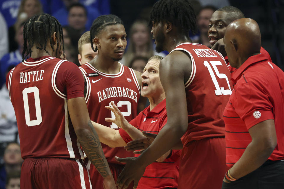 Arkansas head coach Eric Musselman, middle, instructs his team during a stoppage in the second half of an NCAA college basketball game against Kentucky Saturday, March 2, 2024, in Lexington, Ky. Kentucky won 111-102.(AP Photo/James Crisp)