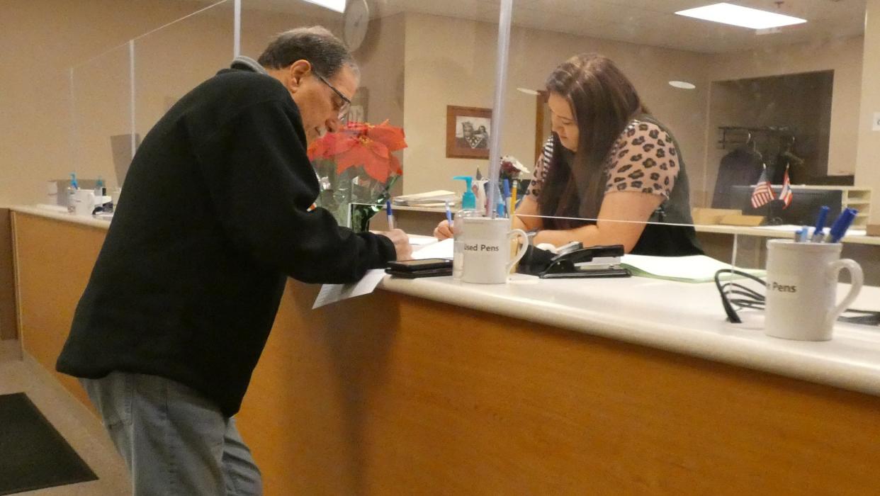 Tim Ley, a Crawford County commissioner, left, takes out his petitions to seek reelection at the Crawford County Board of Elections in December 2021.