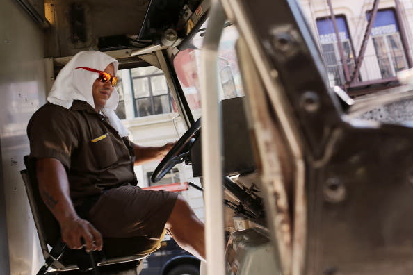 A UPS driver keeps a towel on his head while driving along Broadway during warm weather on July 6, 2012 in New york City. Forecasts for tomorrow are predicting temperatures near 100 degrees Fahrenheit (38 Celsius) and may feel as hot as 106 because of humidity, according to the National weather Service. Much of the midwest of the United States has been experiencing a severe heat wave which has devastated crops and kept people indoors. (Photo by Spencer Platt/Getty Images)