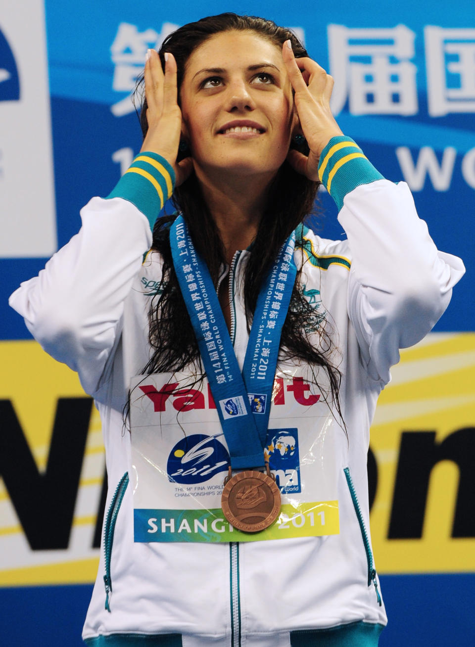 Australia's bronze medalist Stephanie Rice smiles on the podium during the award ceremony for the final of the men's 400-meter individual medley swimming event in the FINA World Championships at the indoor stadium of the Oriental Sports Center in Shanghai on July 31, 2011. (MARK RALSTON/AFP/Getty Images)
