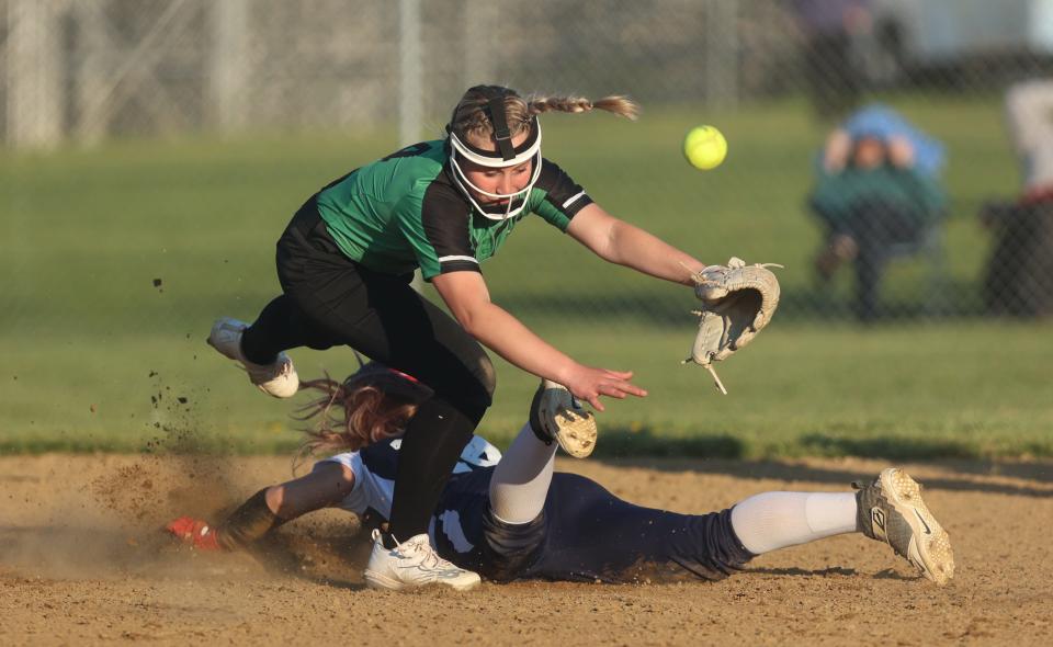 Rootstown's Jessica Hahn slides into second base as Mogadore's Lily Hotchkiss leaps over her.
