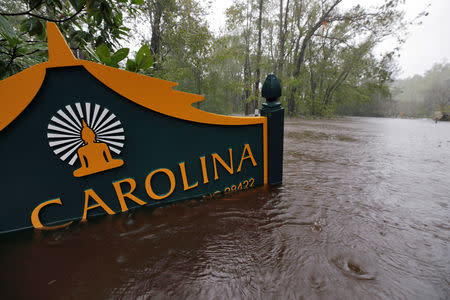 A sign for the Buddhist Association of North Carolina is partially submerged as waters rise after Hurricane Florence swept through, in Bolivia, North Carolina, U.S. September 15, 2018. REUTERS/Jonathan Drake