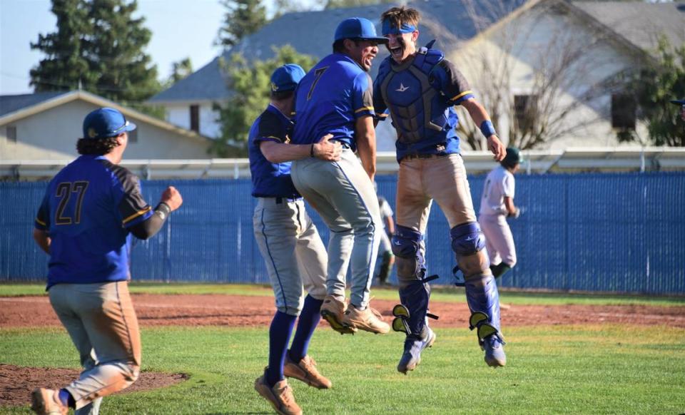 Dos Palos High School pitcher Isac Mandujano (7) celebrates with catcher Peyton Van Worth after the Broncos record the final out of a 4-3 victory over Dinuba in the Central Section Division III semifinal game on Tuesday, May 23, 2023 at Dos Palos High School.