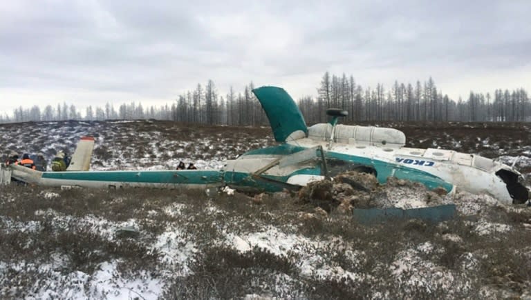 A handout picture from Russia's Emergencies Ministry on October 22, 2016 shows Russian rescuers working at the site where a Mi-8 helicopter crashed