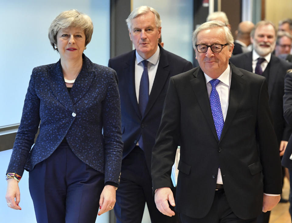 European Commission President Jean-Claude Juncker, British Prime Minister Theresa May and European Union chief Brexit negotiator Michel Barnier, center, walk to their meeting at the European Commission headquarters in Brussels, Thursday, Feb. 7, 2019. (AP Photo/Geert Vanden Wijngaert)