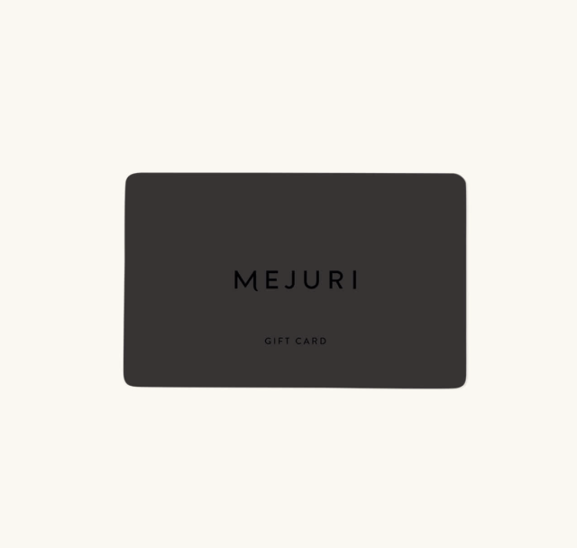 Mejuri Gift Card in black on cream background (Photo via Mejuri)