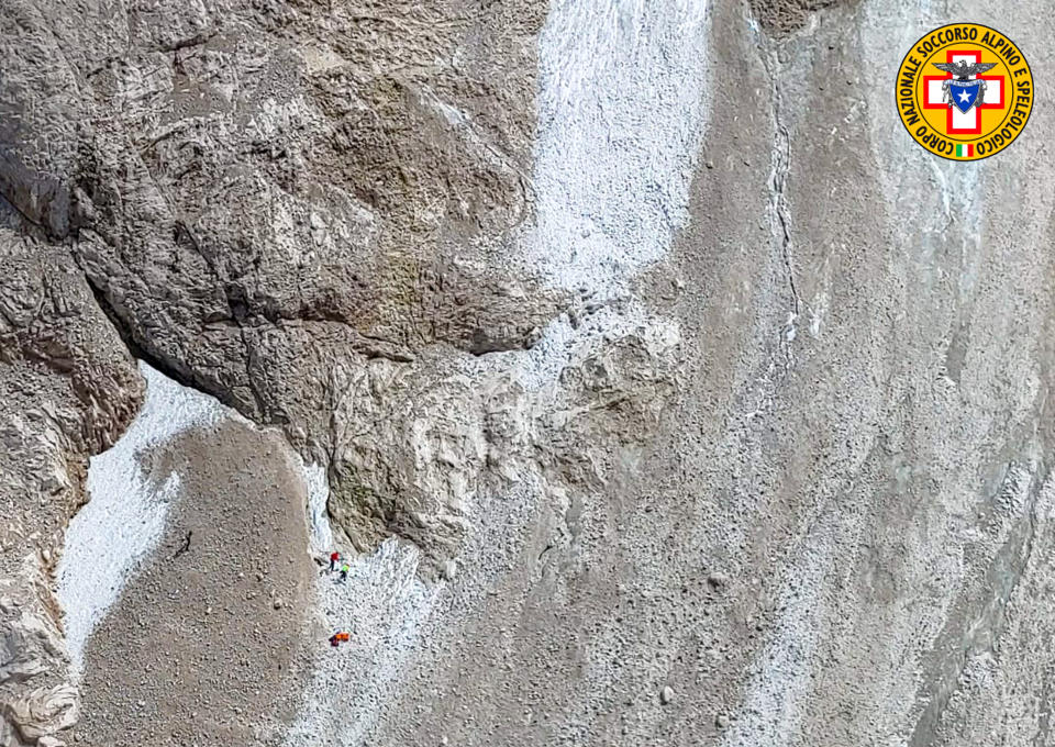 This image released on Sunday, July 3, 2022, by the Italian National Alpine and Cave Rescue Corps shows the rescue operations on the glacier in Italy's Alps near Trento a large chunk of which has broken loose, killing at least six hikers and injuring eight others. Alpine rescue service officials, which provided that toll Sunday evening, said it could take hours to determine if any hikers might be missing. The National Alpine and Cave Rescue Corps tweeted that the search of the involved area of Marmolada peak involved at least five helicopters and rescue dogs. (Corpo Nazionale Soccorso Alpino e Speleologico via AP)