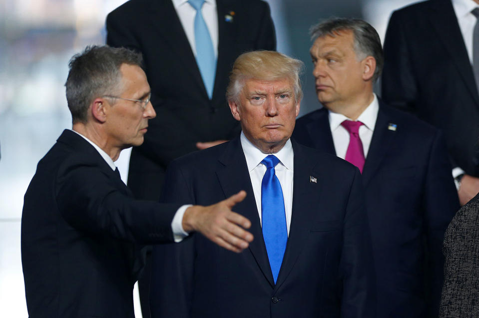 <p>NATO Secretary General Jens Stoltenberg (L) directs U.S President Donald Trump who takes his place as NATO member leaders gather before the start of their summit in Brussels, Belgium, May 25, 2017. (Hannibal Hanschke/Reuters) </p>