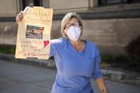 A counter-protester is seen near Capitol Square during a rally to demand that Gov. Ralph Northam (D) lift restrictions that have closed certain businesses in Virginia since the coronavirus outbreak in Richmond, Va., on Wednesday, April 22, 2020. (Photo By Tom Williams/CQ Roll Call)