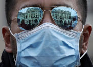 A man wears a face mask in St. Peter's Square at the Vatican during Pope Francis' weekly general audience, Wednesday, Feb. 26, 2020. (AP Photo/Alessandra Tarantino)