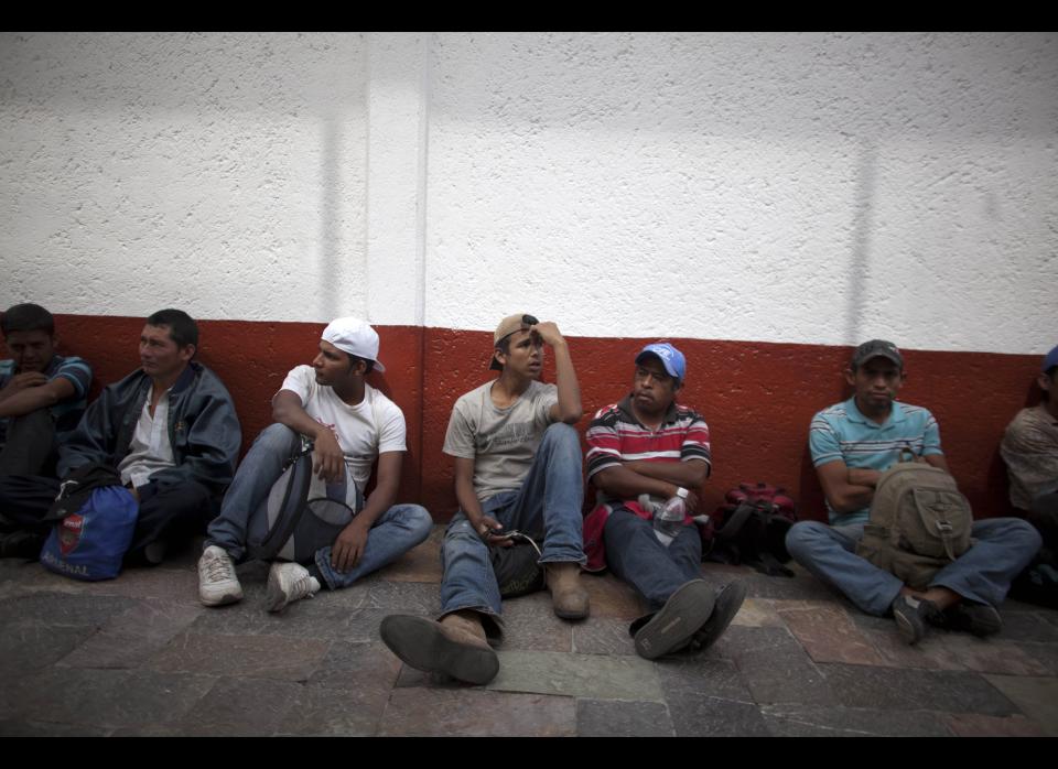 In this May 17, 2012 photo, migrants sit outside the mayor's residence after protesting violence against migrants in Lecheria, on the outskirts of Mexico City. While the number of Mexicans heading to the U.S. has dropped dramatically, a surge of Central American migrants is making the 1,000-mile northbound journey this year, fueled in large part by the rising violence brought by the spread of Mexican drug cartels. (AP Photo/Alexandre Meneghini)