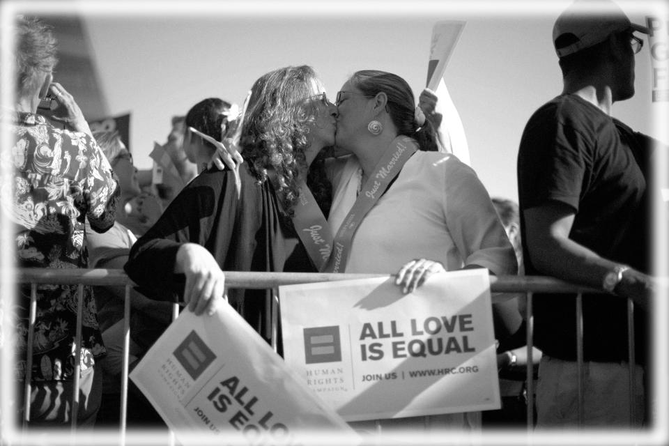 Deirdre Weaver (L), 47, and her wife Nancy Grass, 48, who have been together for 15 years, kiss at a rally in West Hollywood, California after the United States Supreme Court ruled on California's Proposition 8 and the federal Defense of Marriage Act June 26, 2013.   (Photo: Lucy Nicholson/Reuters; digitally enhanced by Yahoo News)