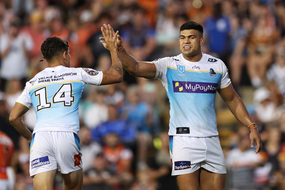 Pictured right, Gold Coast forward David Fifita giving teammate Jayden Campbell a high five during the NRL round one win over the Tigers.