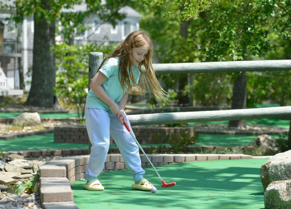 Nora Harper, 7 1/2, of Foxboro, plays through at a hole on the mini golf course at Arnold's Lobster & Clam Bar in Eastham.