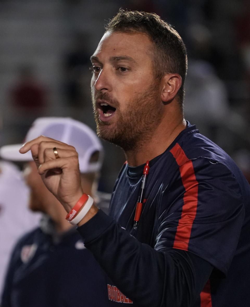 Quakers head coach Tyler Bless addresses players after the Quaker’s 46-20 win against the Greenfield Woodmen on Friday, Sept. 15, 2023, at Plainfield High School in Plainfield.