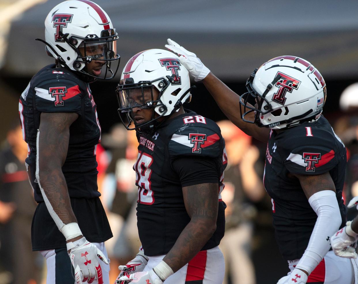 From left to right: Texas Tech's wide receiver Jerand Bradley (9), Texas Tech's running back Tahj Brooks (28) and Texas Tech's wide receiver Myles Price (1) celebrate BrooksÕ touchdown in the first overtime against Houston, Saturday, Sept. 10, 2022, at Jones AT&T Stadium. 