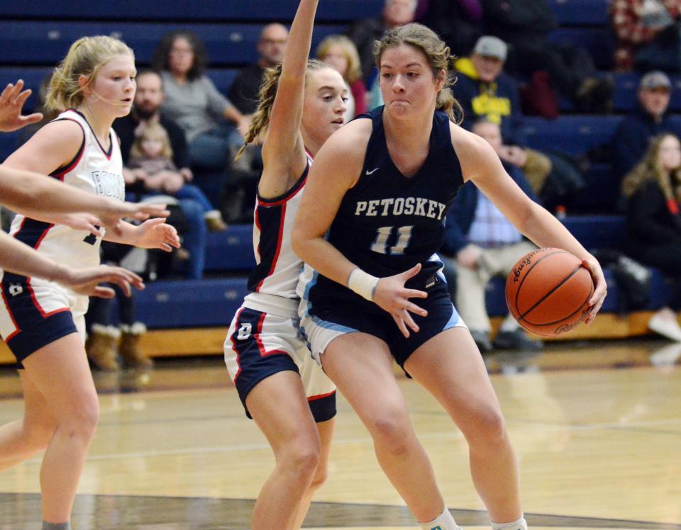 Petoskey's Grayson Guy makes a move to the basket while guarded by Boyne City's Ava Maginity during the second half.