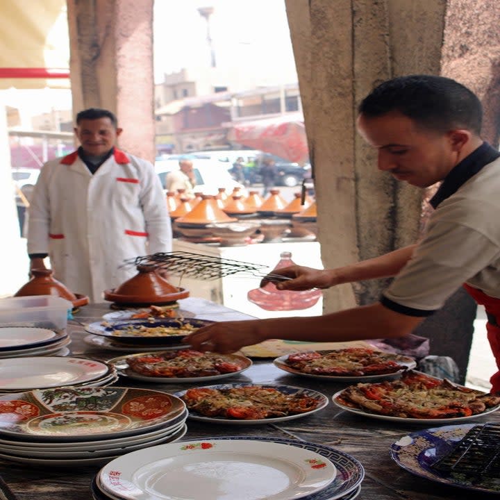 Men preparing and plating food