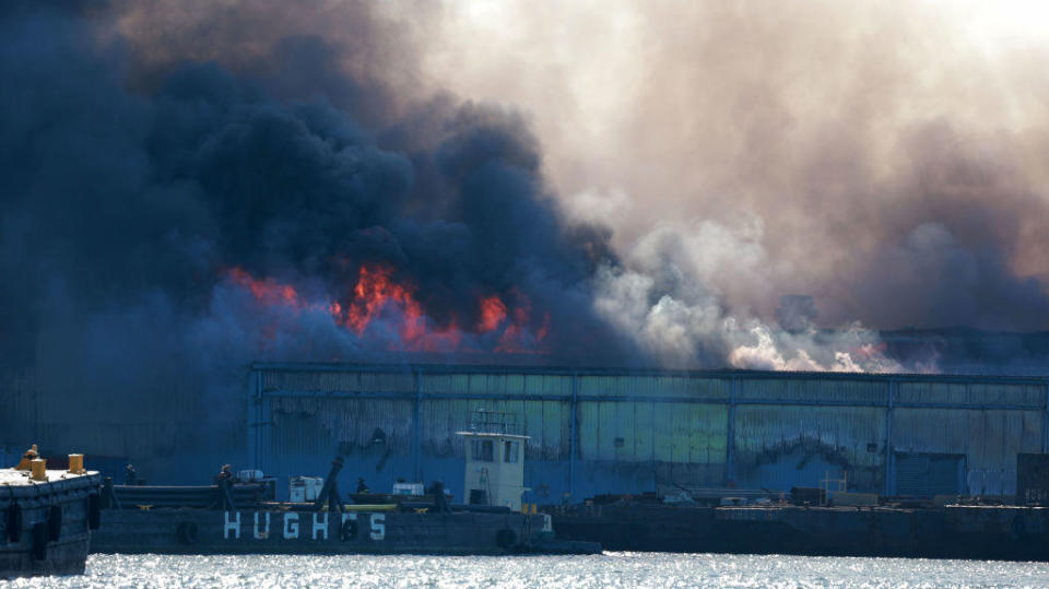 A blaze broke out at the Erie Basin Auto Pound on Columbia Street in Red Hook at about 10:30 a.m. Tuesday, Dec. 13, 2022, authorities said. / Credit: New York Daily News