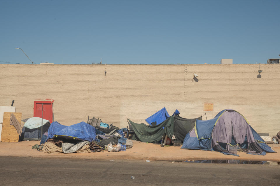 People’s tents line a street in one of Phoenix’s biggest encampments for unsheltered people.