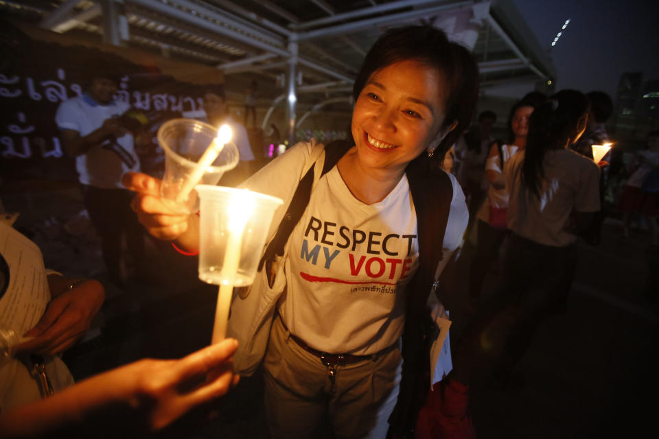 Members of Thailand's "White Shirt" movement light candles during a vigil to demand democratic elections and political reforms in Bangkok, Thailand, Friday, Jan. 31, 2014. Thailand's general election is scheduled for Sunday, Feb. 2, 2014, but the main opposition Democrat Party is boycotting it, and its supporters seeking to scuttle it by blocking access to polling stations throughout Bangkok. (AP Photo/Wally Santana)