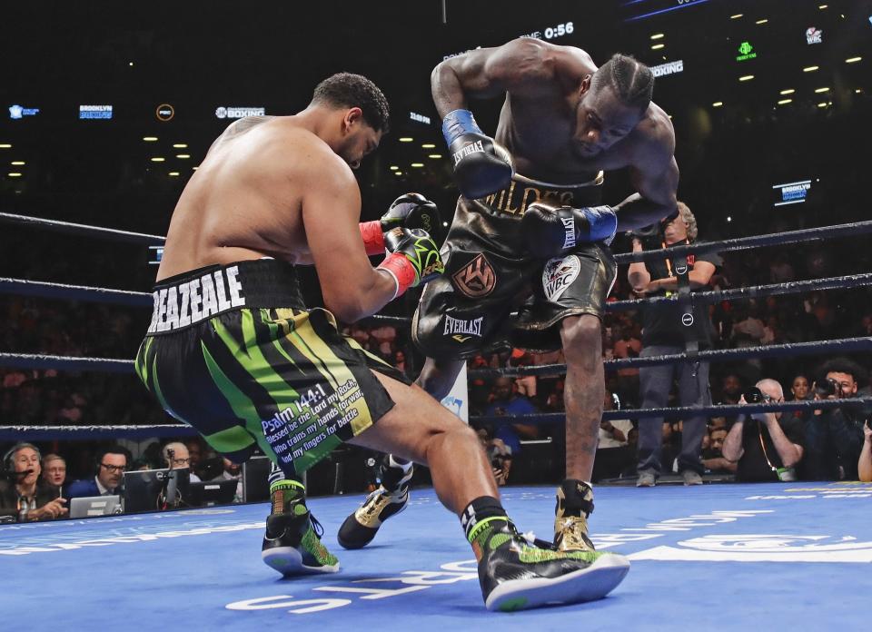 Deontay Wilder, right, knocks down Dominic Breazeale during the first round of the WBC heavyweight championship boxing match Saturday, May 18, 2019, in New York. Wilder stopped Breazeale in the first round. (AP Photo/Frank Franklin II)