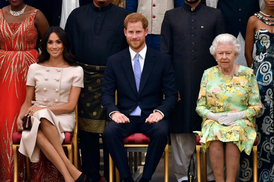 Queen Elizabeth, Prince Harry and Meghan, Duchess of Sussex (AP)