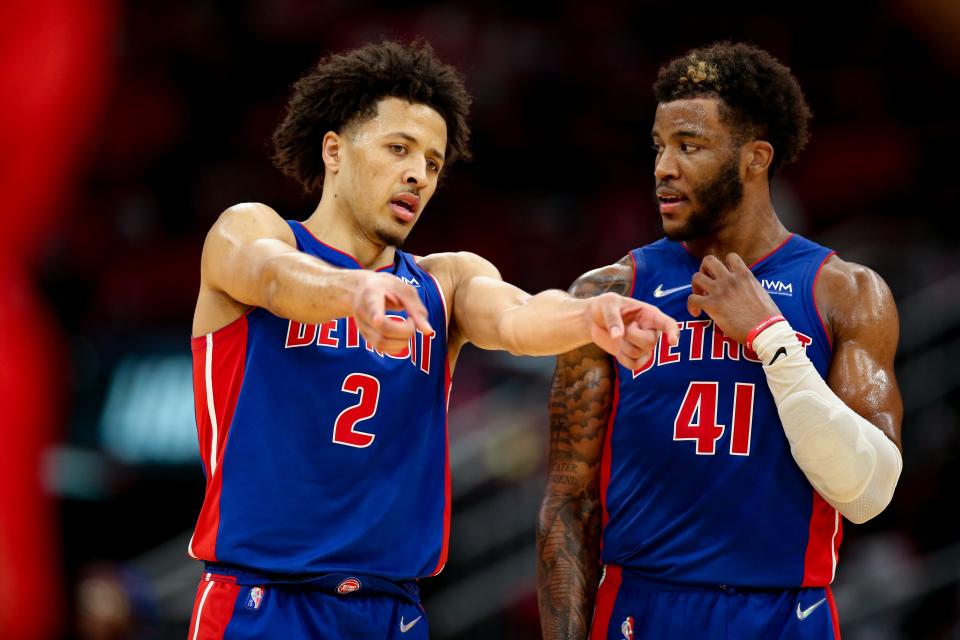 Cade Cunningham #2 of the Detroit Pistons speaks with Saddiq Bey #41 during the second half against the Houston Rockets at Toyota Center on November 10, 2021 in Houston, Texas.