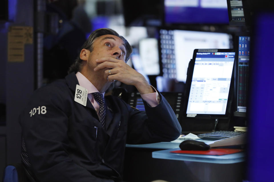 FILE - In this Aug. 7, 2019, file photo trader John Romolo works on the floor of the New York Stock Exchange. Markets are coming off a fabulous 2019, where stocks, bonds and other investments climbed in concert. But for the next year, and decade, in fact, Wall Street is telling investors to set their expectations considerably lower. (AP Photo/Richard Drew, File)