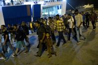 Migrants disembark from a ferry at the port of Piraeus in Athens on September 1, 2015