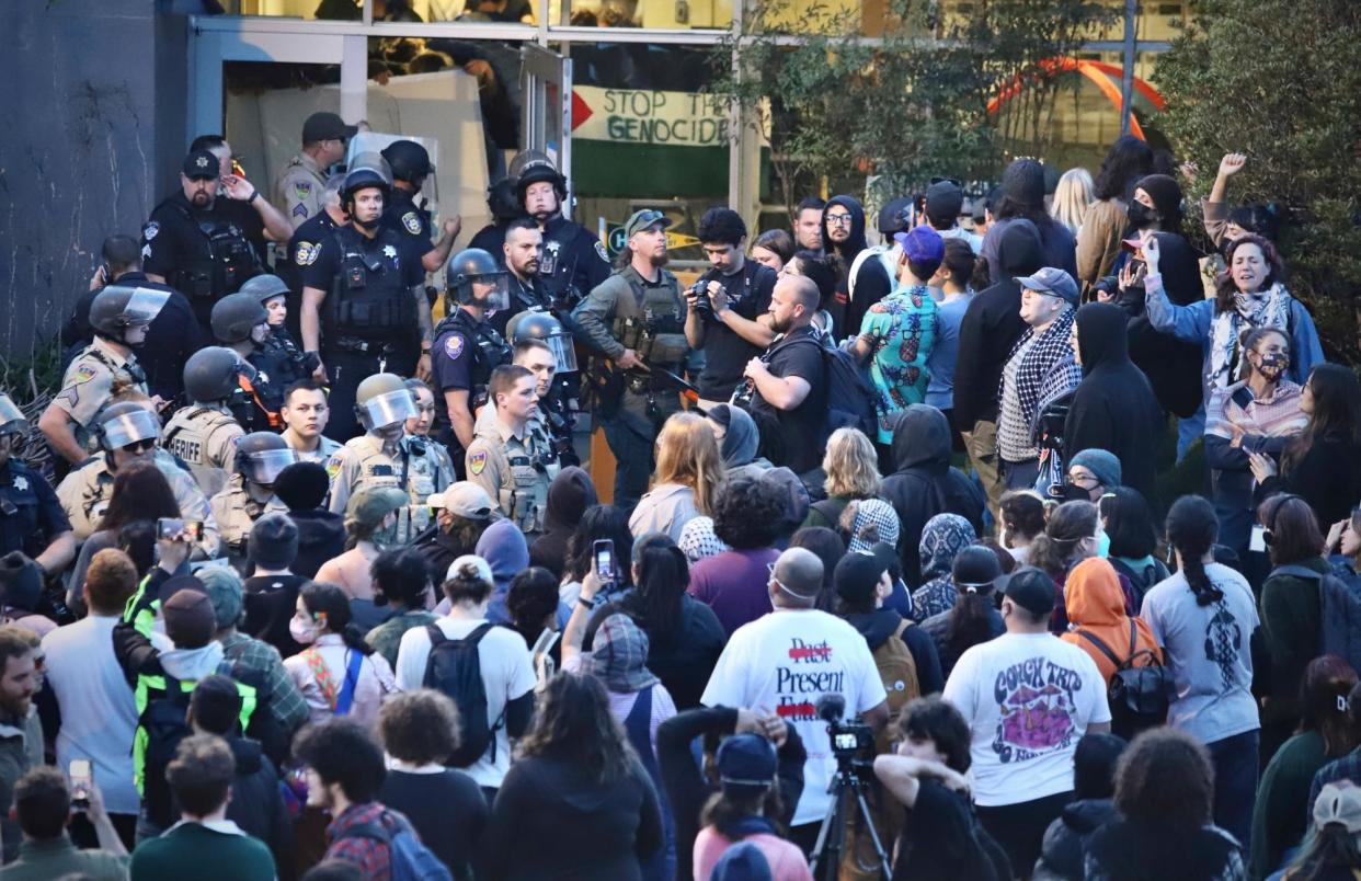 <span>Pro-Palestinian protesters stand off with police on the California State Polytechnic University, Humboldt campus, in Arcata on 22 April.</span><span>Photograph: Andrew Goff/AP</span>